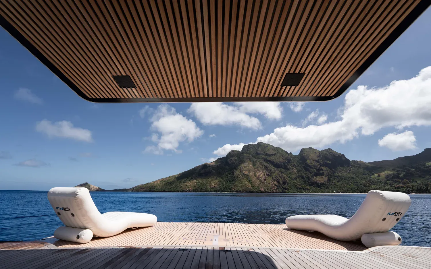 Sun loungers on the aft deck of M/Y Impulsive at dusk